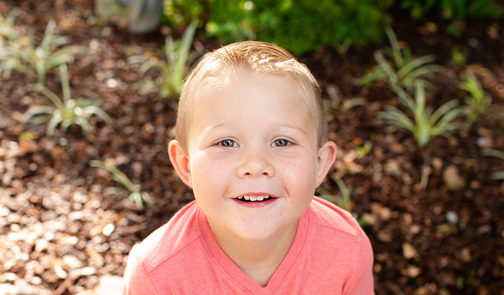 Little boy outside and smiling